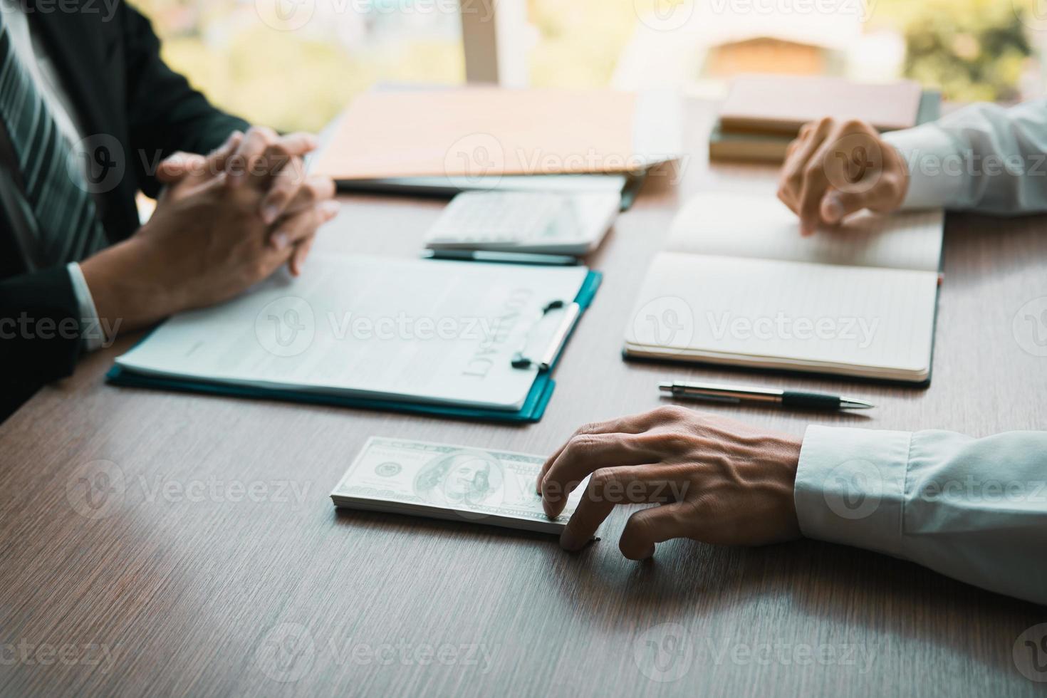 Partner has made a fraud in the contract of sale and being handed a cash and pen to the businessman signing the contract corruption bribery concept. photo