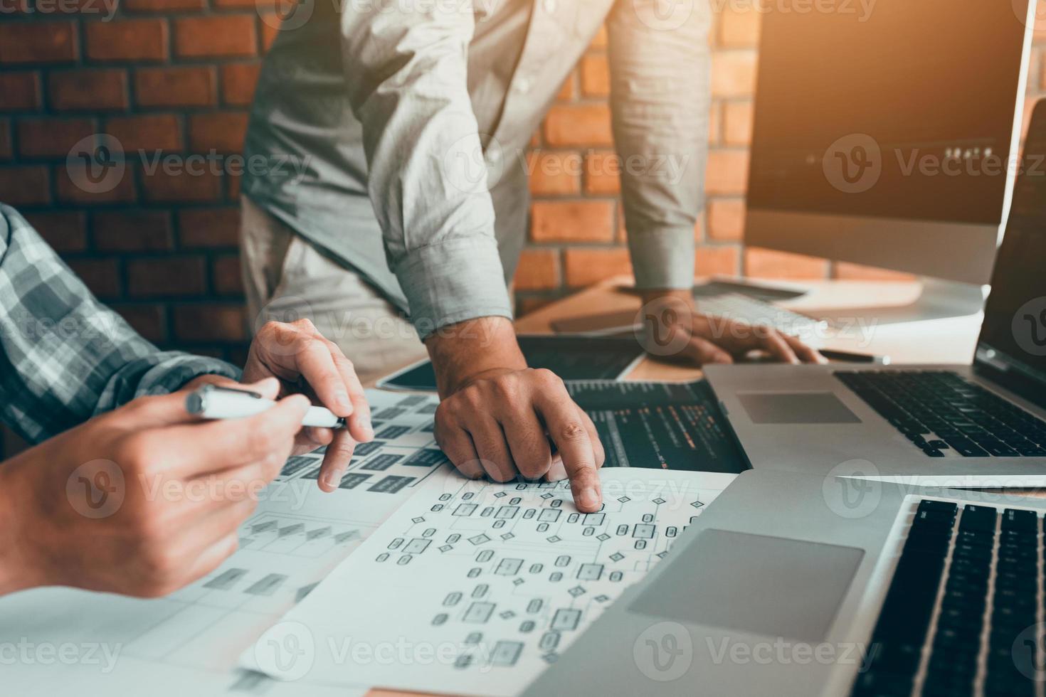 Two software developers are analyzing together about the code written into the program on the computer. photo