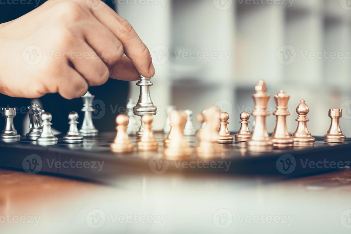 Businessman playing chess game beat opponent with strategy concept. photo