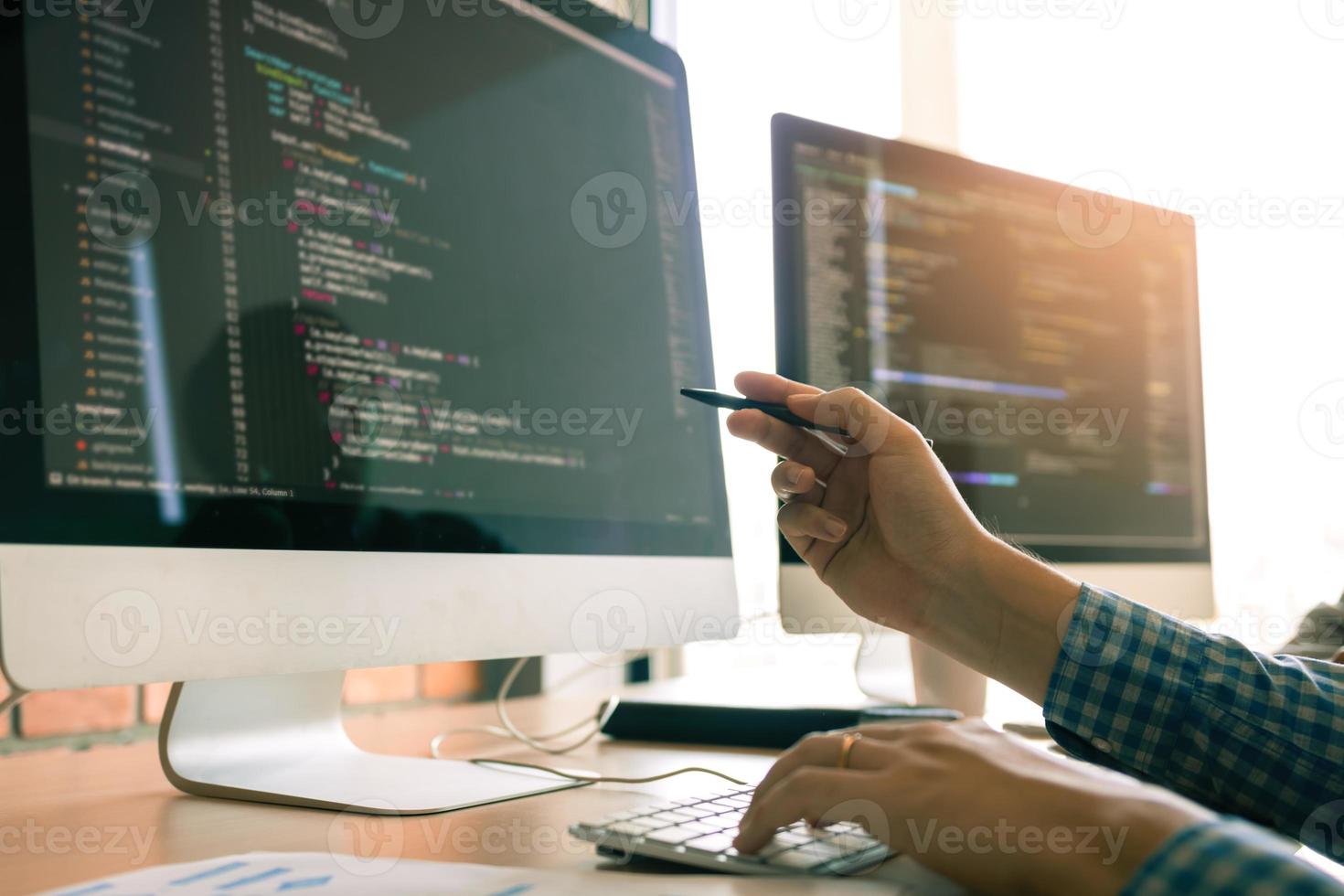 Developing programming working in a software engineers code tech applications on desk in office room. photo