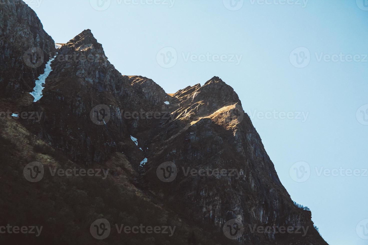 Rock top in sunlight on sky background photo