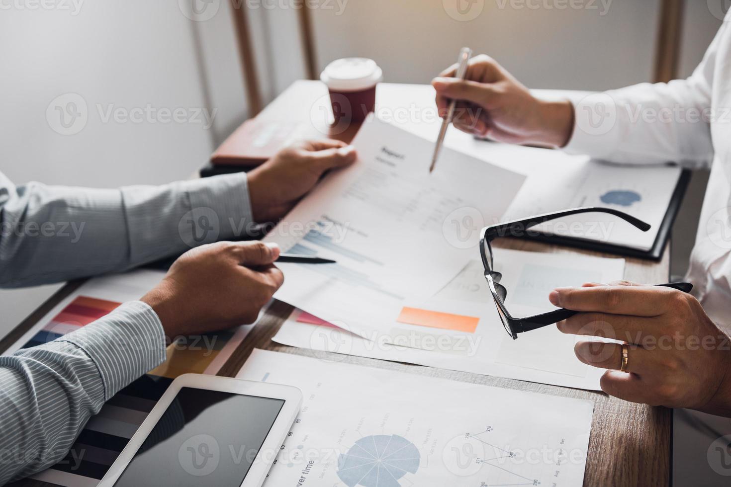 Colleagues are stress talking about the finance results report and compared with the financial information on the paperwork with analysis about planning in the future. photo