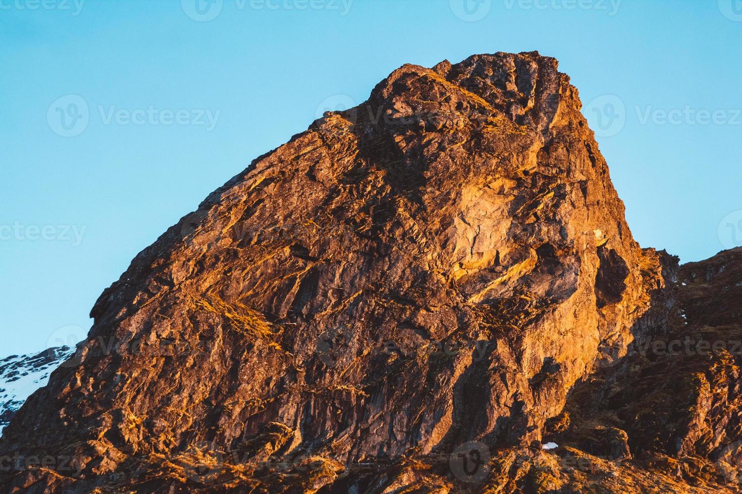 Rock top in sunlight on sky background photo