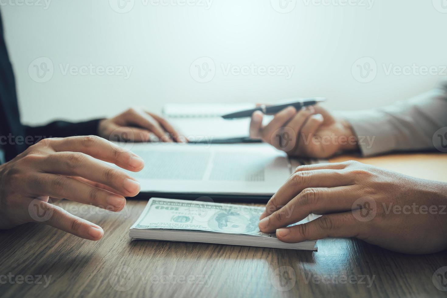 Partner has made a fraud in the contract of sale and being handed a cash and pen to the businessman signing the contract corruption bribery concept. photo