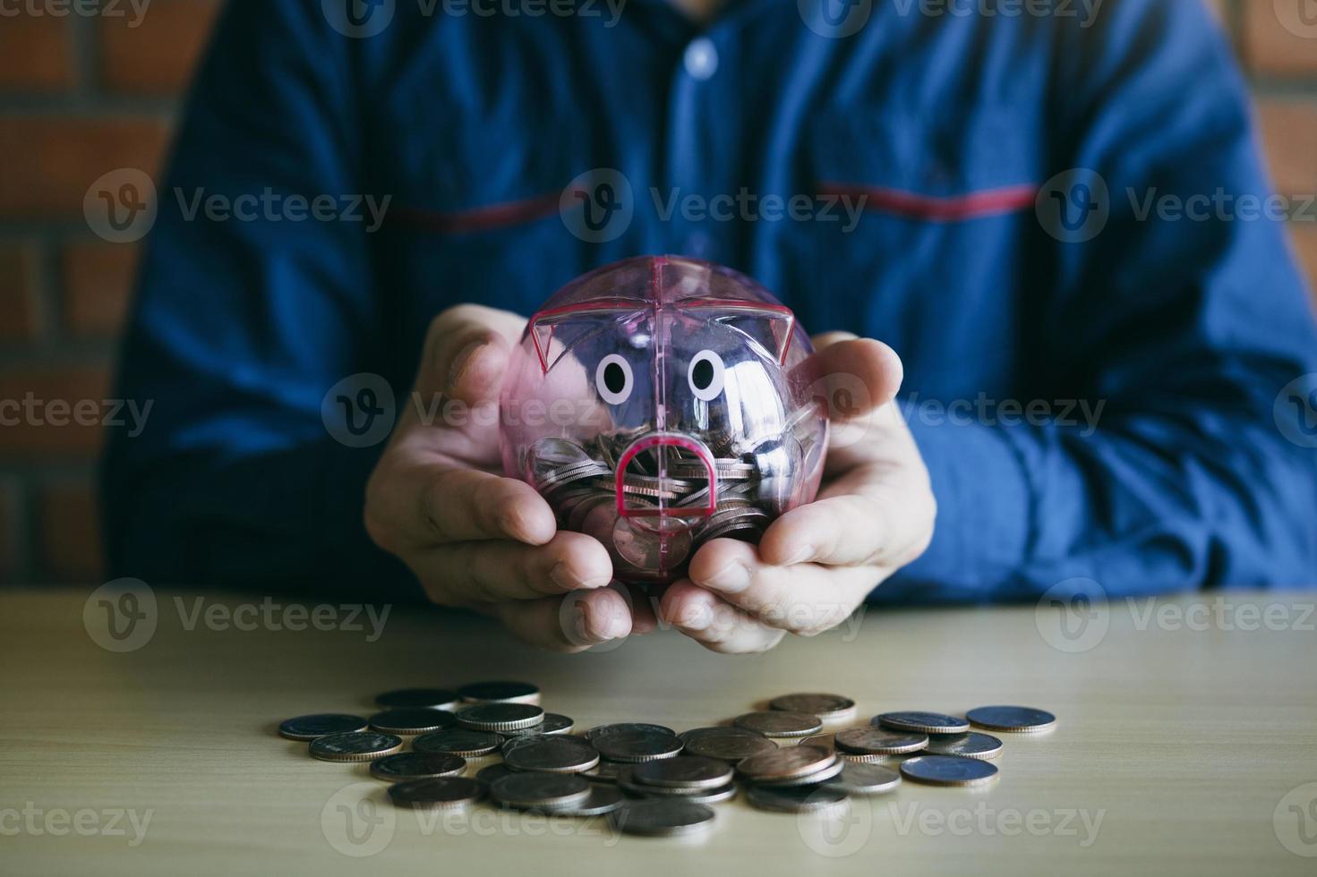 Men carrying holding a piggy bank with a collection concept. photo