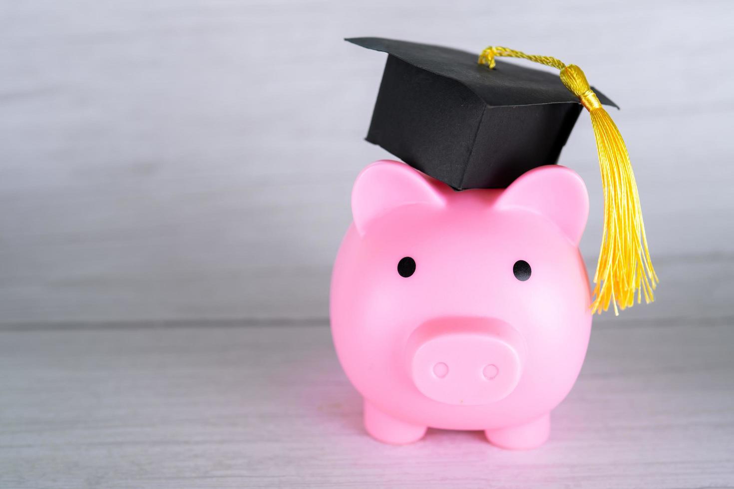 Piggy bank with graduation cap, Business finance education saving money scholarship concept. photo