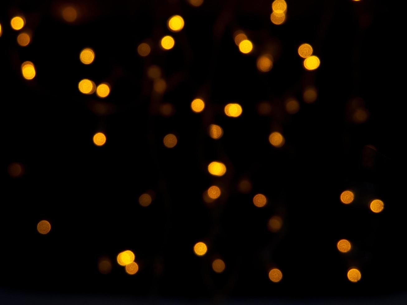 A small bokeh background shining golden light at night, which looks like a fire. photo