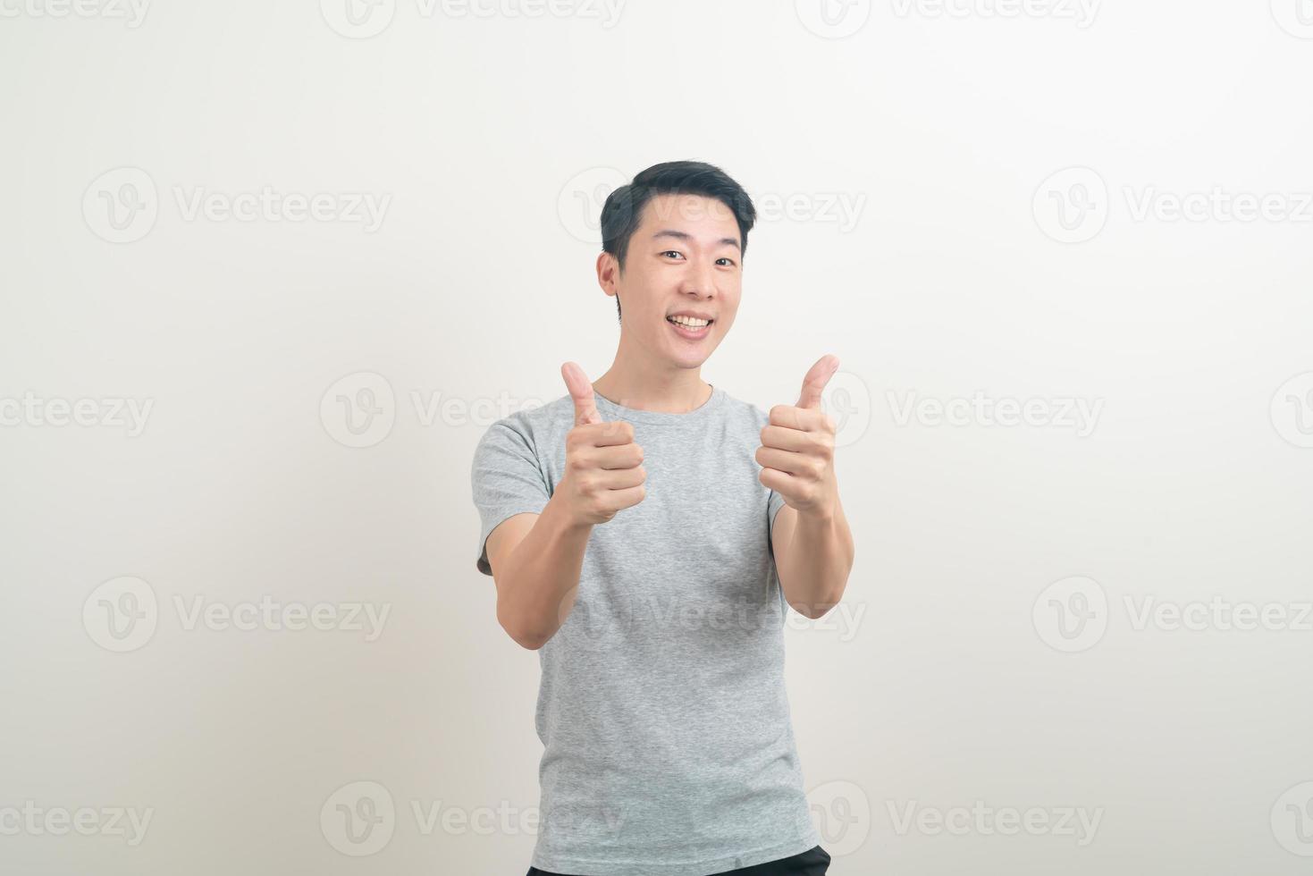 young Asian man thumbs up or ok hand sign photo