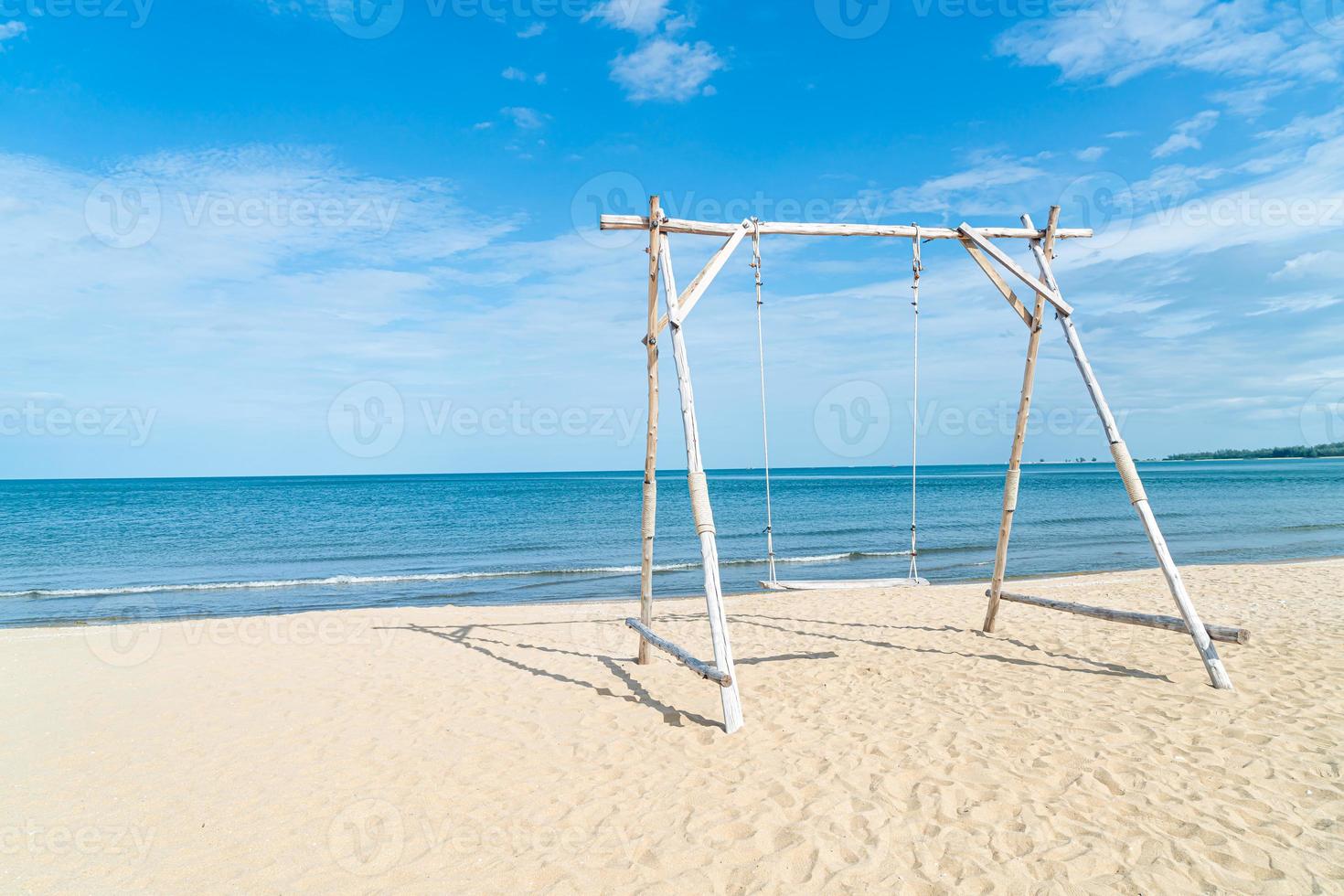 wooden swing on the beach photo