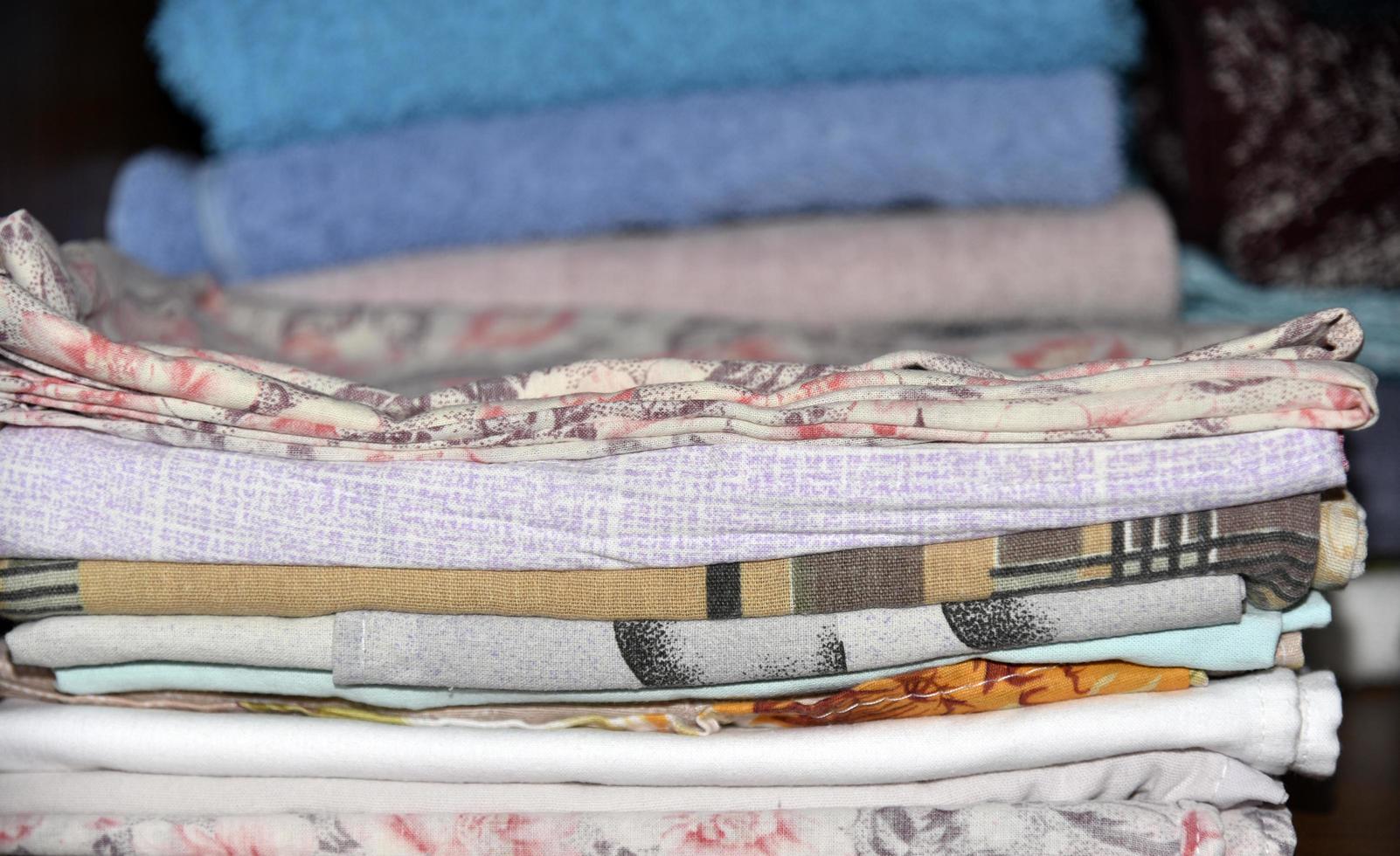 Bath towel and home linen in the closet photo