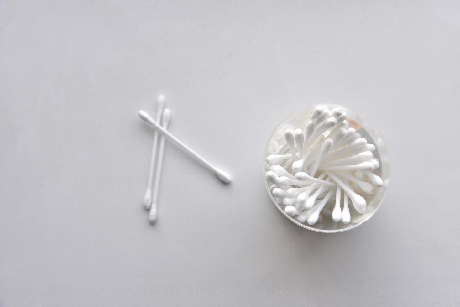 Cotton swabs in a jar on a white background photo