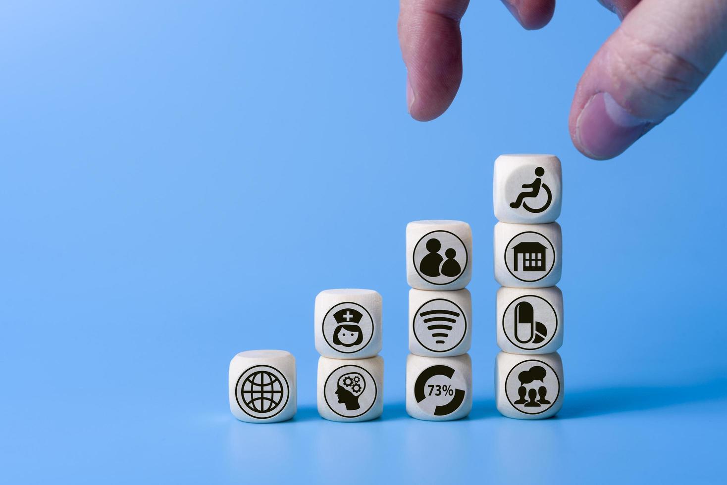 Concept of disability with icons on wooden cubes. on a blue background. photo