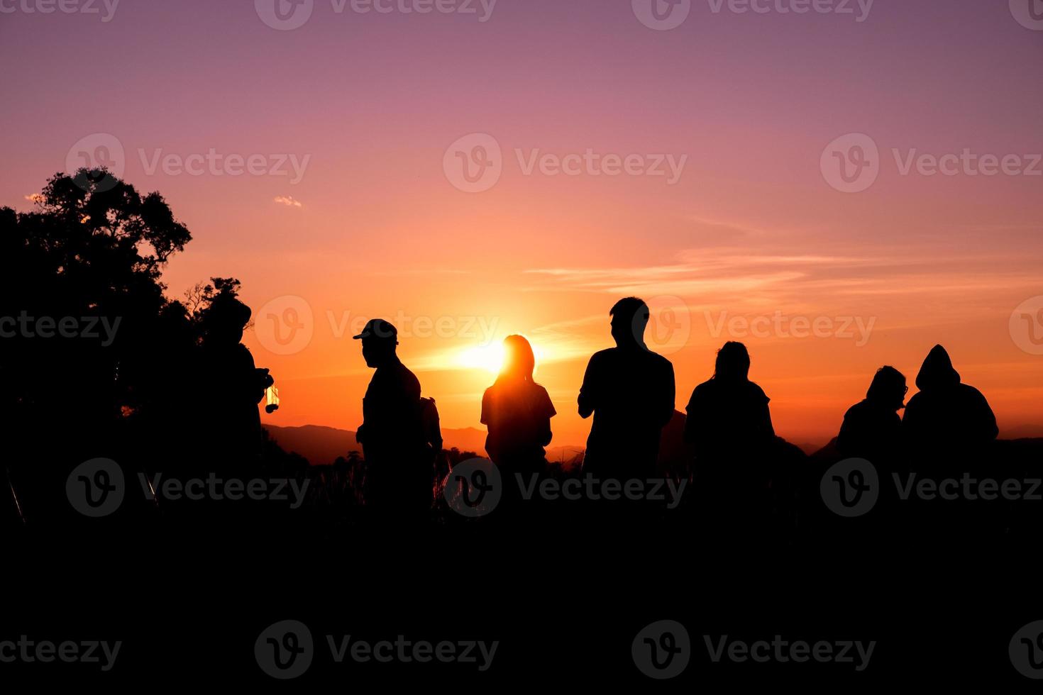 Silhouette tourists stand looking view photo