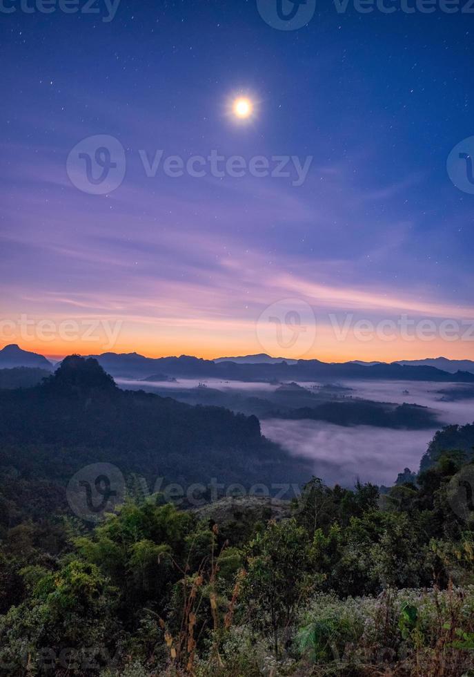 Viewpoint mist mountain colorful with the moon at dawn photo