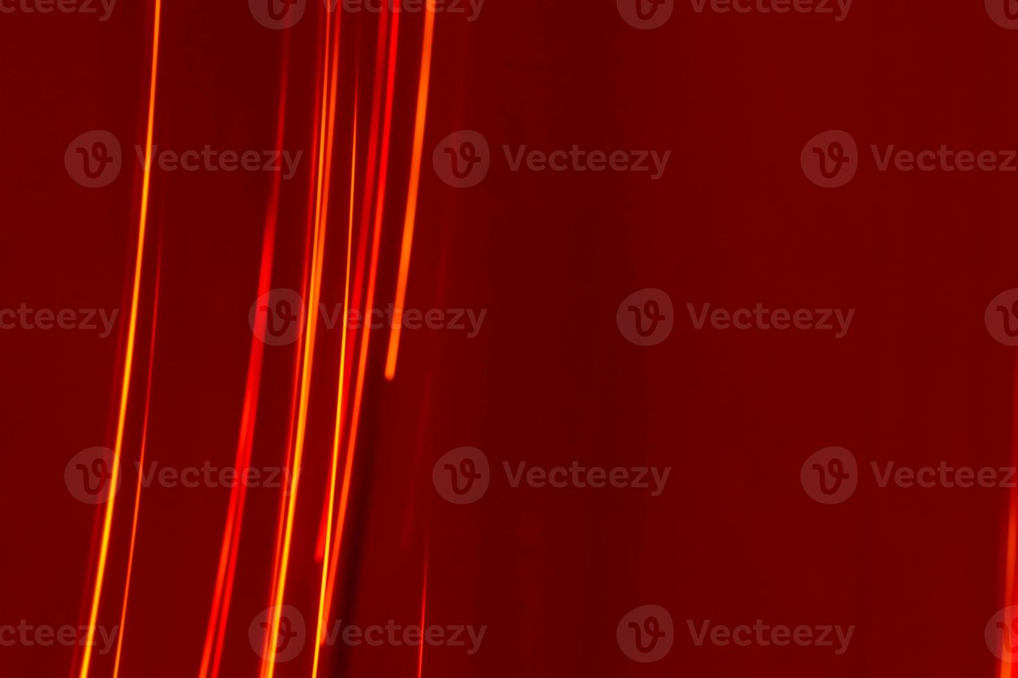 Bright red lines rays on a burgundy background. Abstract backdrop with soft blur. photo