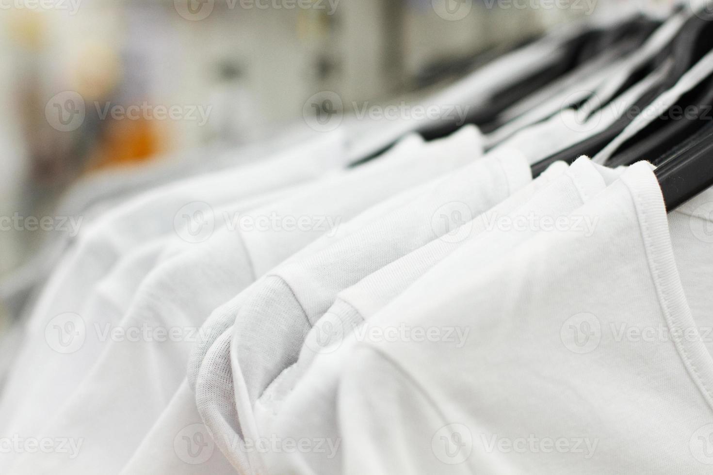 algunas ropas usadas colgadas en un perchero en un mercado de pulgas. fondo de vestido. enfoque selectivo. foto