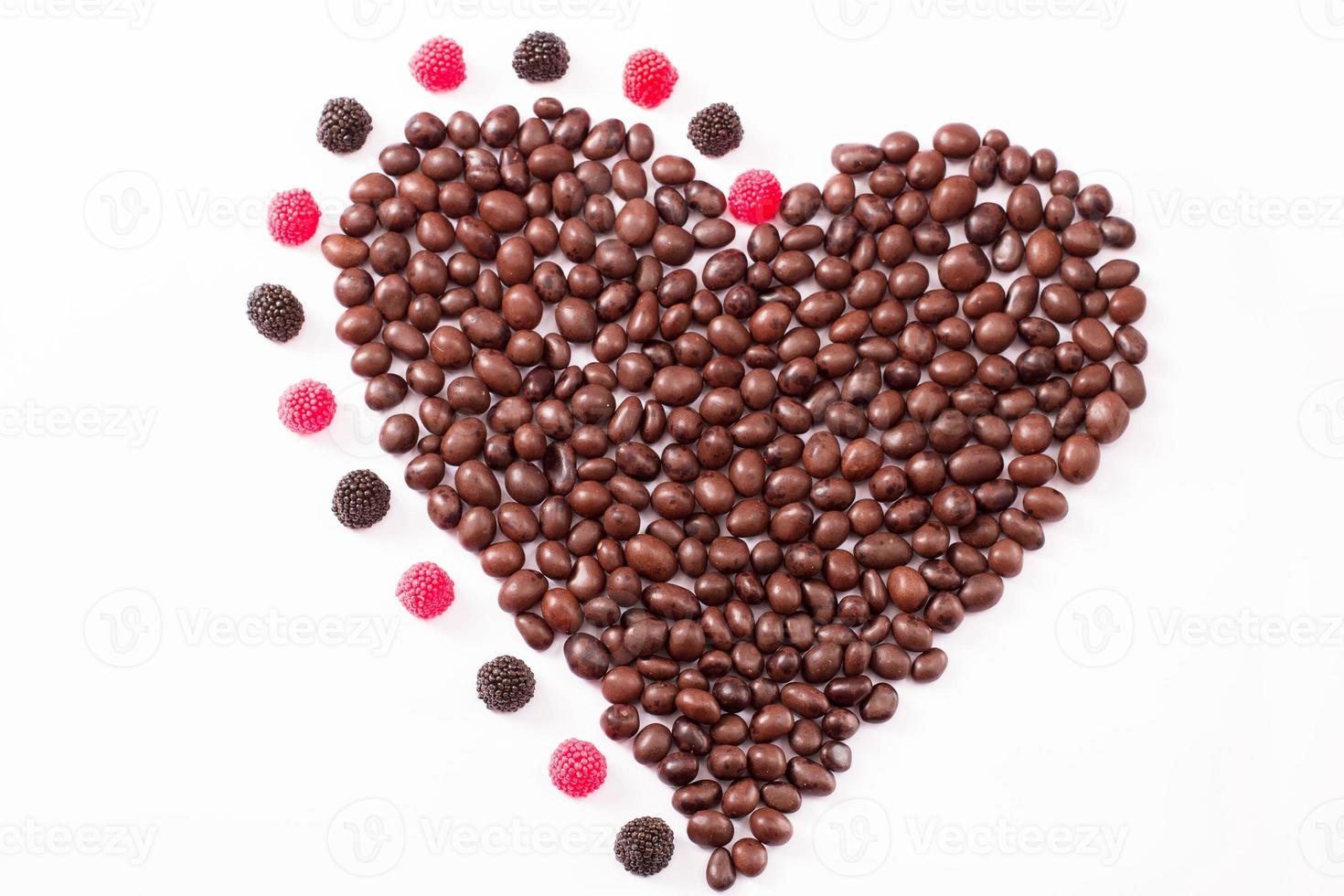 Candy and sweets isolated on white background. Heart shape. Top view. Selective focus. Copy space and mock up photo