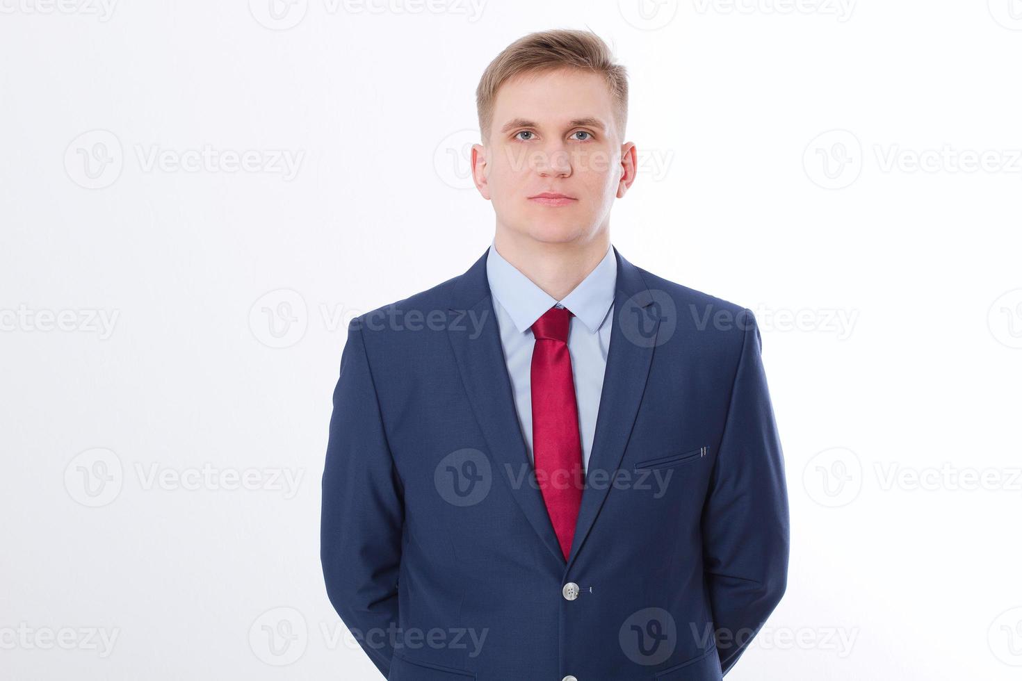 Serious businessman in blue suit and red tie isolated on white background. Business concept. Copy space and mock up photo