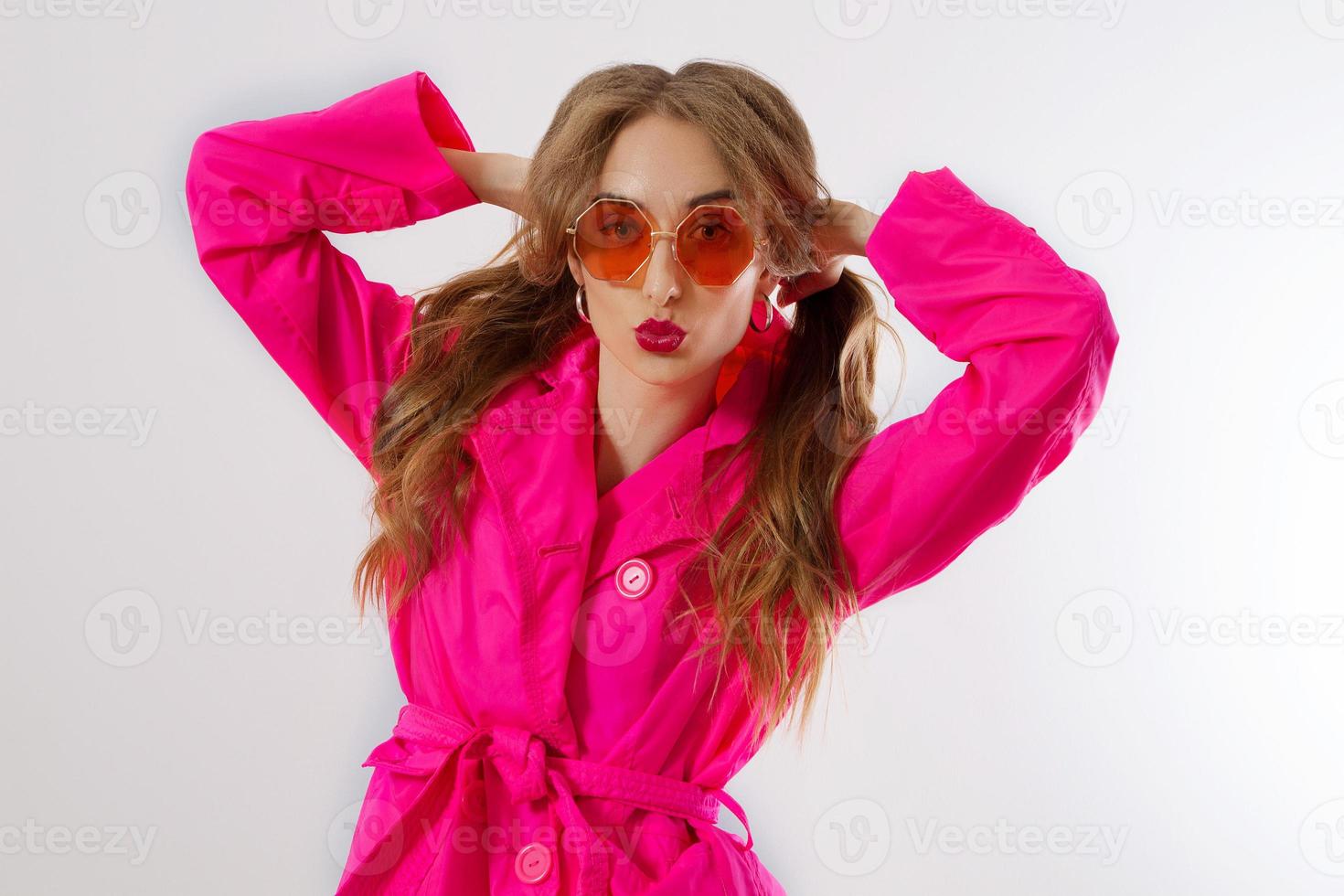 Crazy funny girl face and ponytail hairstyle. Happy woman with fun face  isolated on white background. Beautiful Lady in pink coat and red  sunglasses. Fashionable and trendy outfit. Glamour model 5418825 Stock