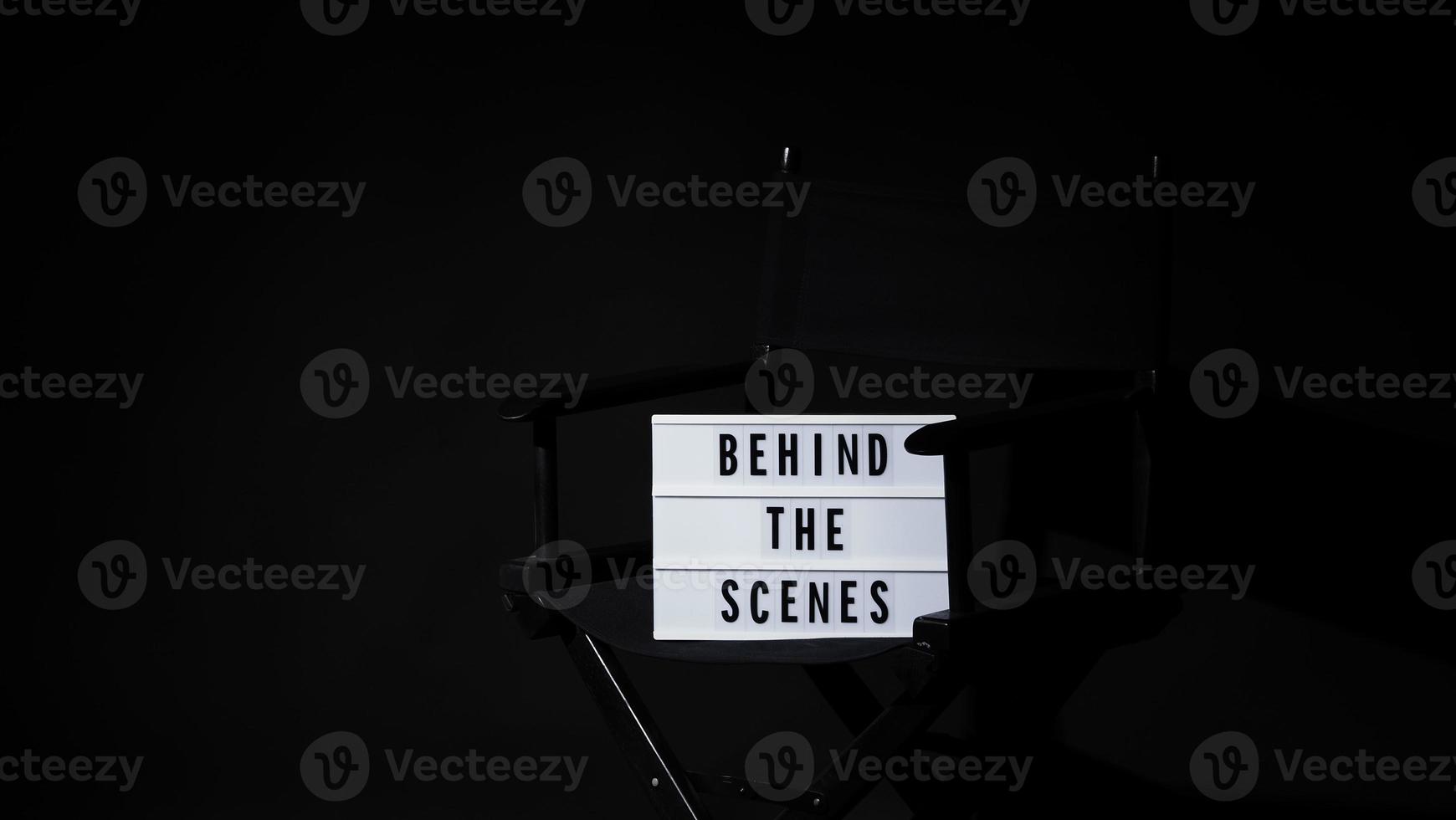 Director chair with behind the scene banner light box. photo