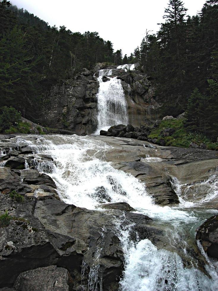 Waterfall of a river in the mountains photo