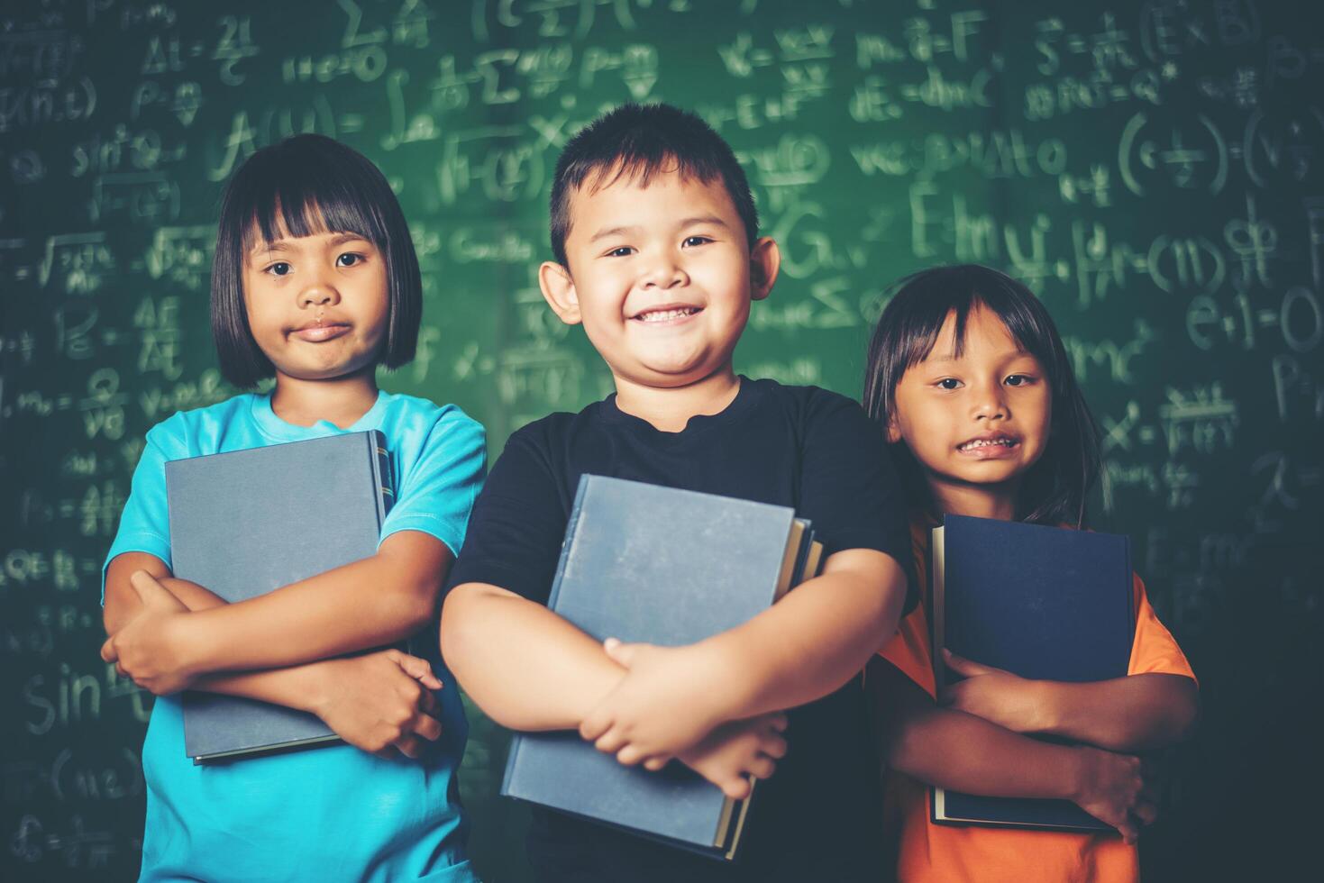 schoolgirl holding a book in the classroom. photo