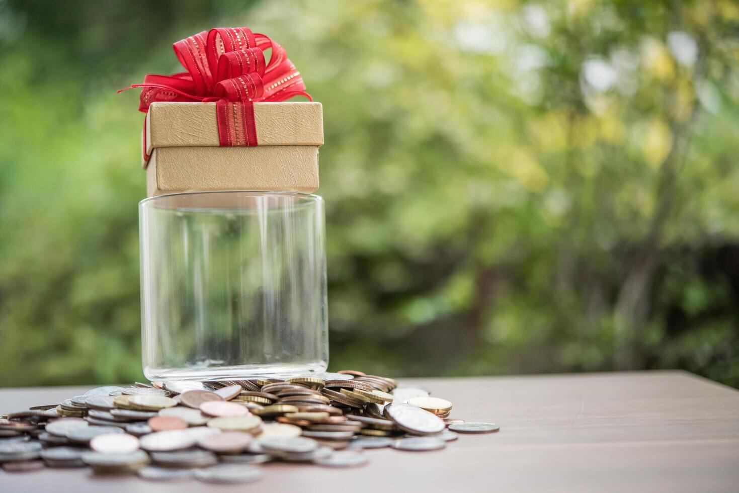Gift box on dollars  in the glass jar photo