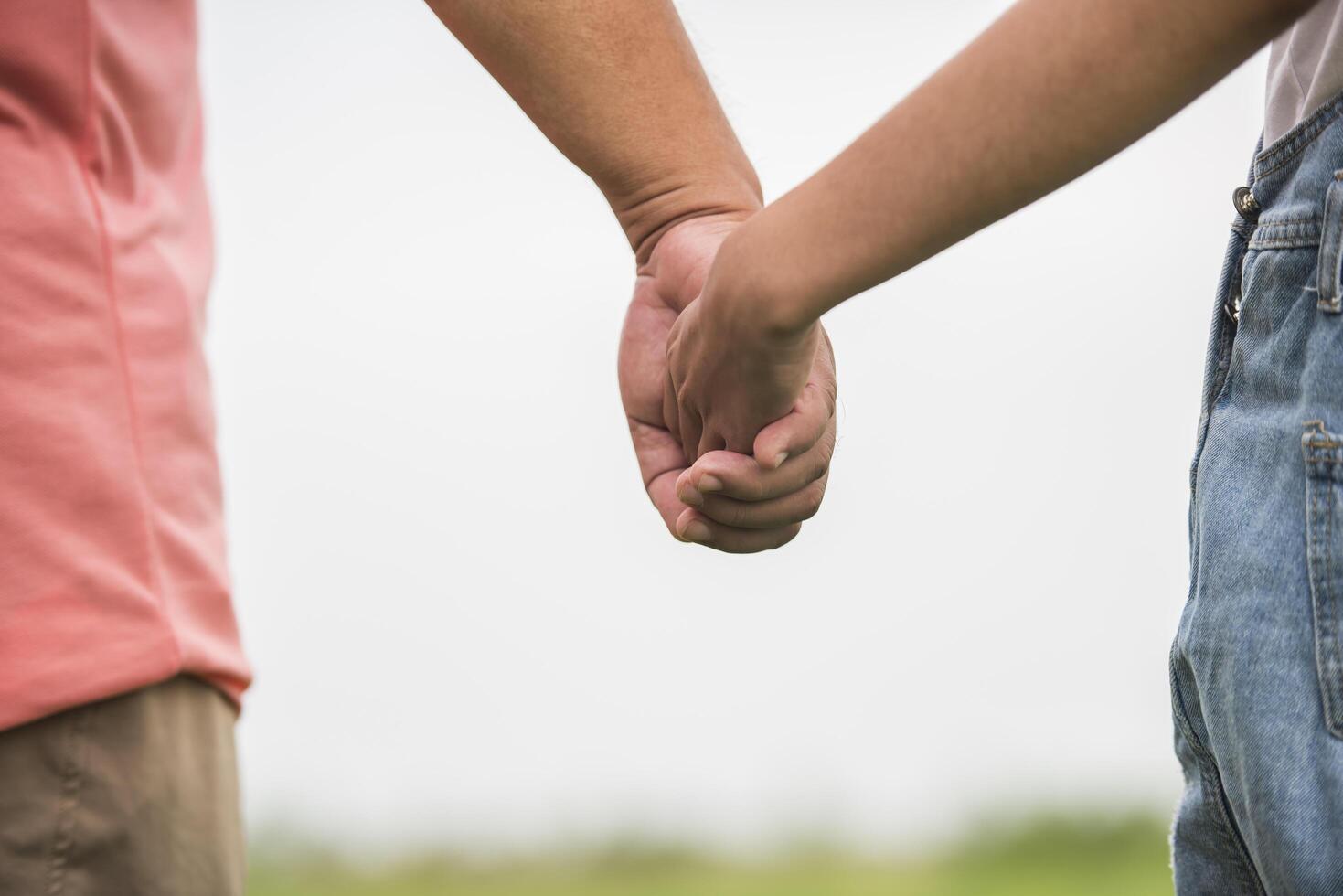 Father and daughter holding hand in hand together photo
