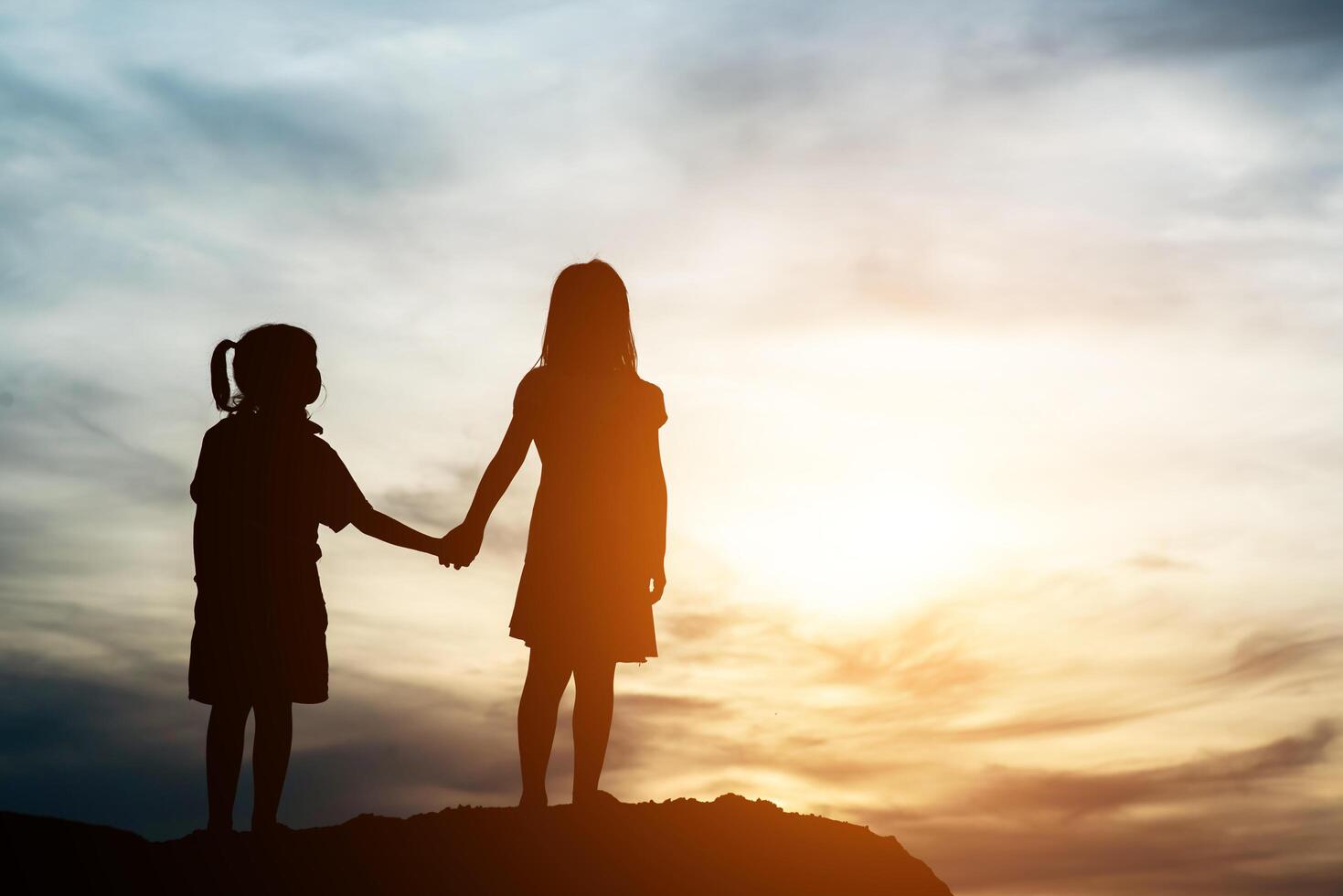 Silhouette of two girl having fun in nature photo