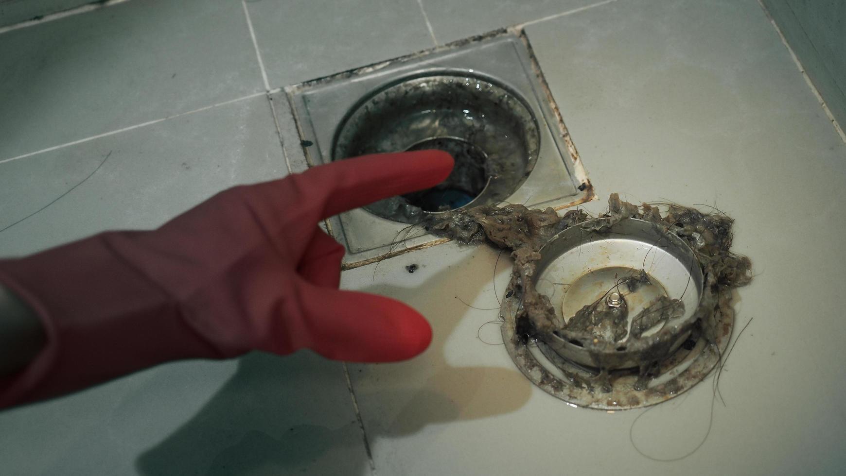Drain cleaning. Clogged and dirty sewer pipes floor drain. photo
