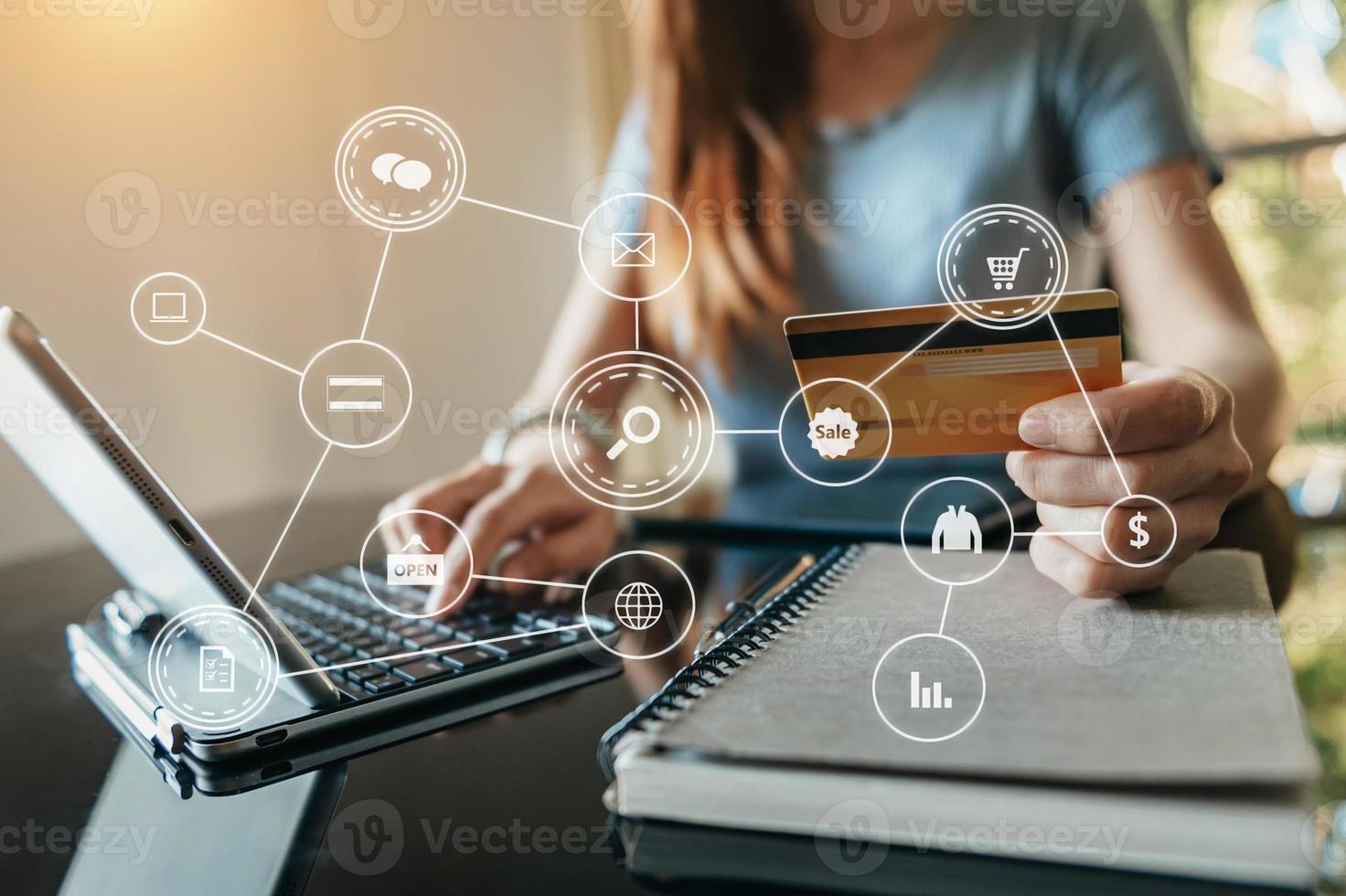 Close up of Hand using credit card and smartphone, laptop computer on wooden desk with VR icon photo