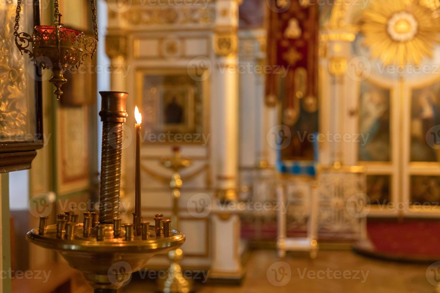 Orthodox Church. Christianity. Festive interior decoration with burning candles and icon in traditional Orthodox Church on Easter Eve or Christmas. Religion faith pray symbol. photo