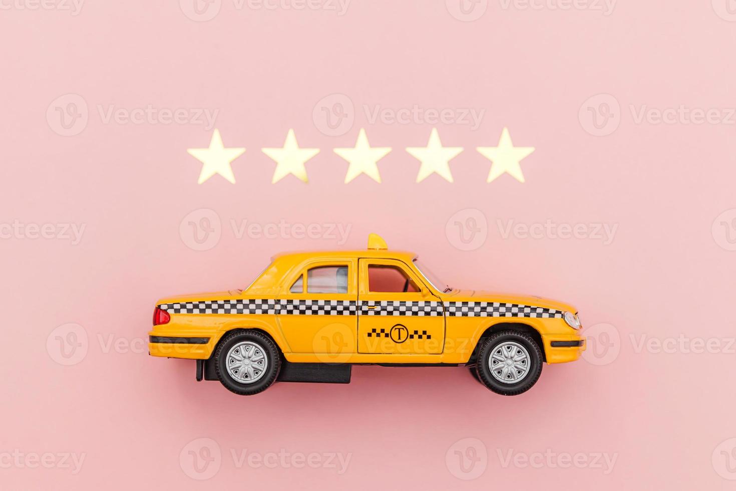 Yellow toy car Taxi Cab and 5 stars rating isolated on pink background. Smartphone application of taxi service for online searching calling and booking cab concept. Taxi symbol. Copy space. photo