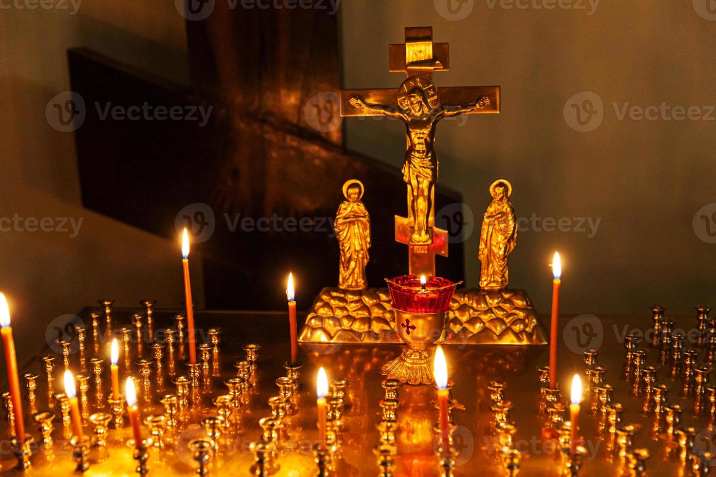 Orthodox Church. Christianity. Festive interior decoration with burning candles and icon in traditional Orthodox Church on Easter Eve or Christmas. Religion faith pray symbol. photo