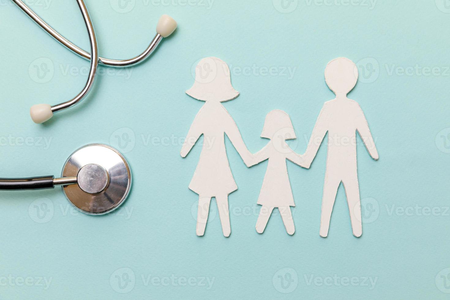 Family health care therapy medical concept. Flat lay family cutout symbol model stethoscope on pastel blue background. Health check up life insurance concept. Clinic hospital for parents child banner. photo