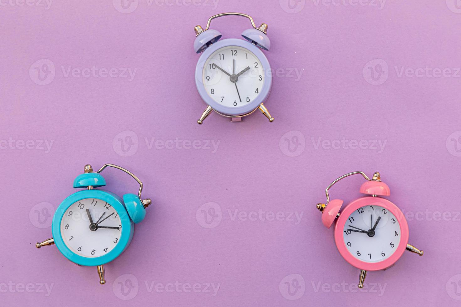 Simply minimal design three ringing twin bell classic alarm clock Isolated on purple violet background. Rest hours time of life good morning night wake up awake concept. Flat lay top view copy space. photo
