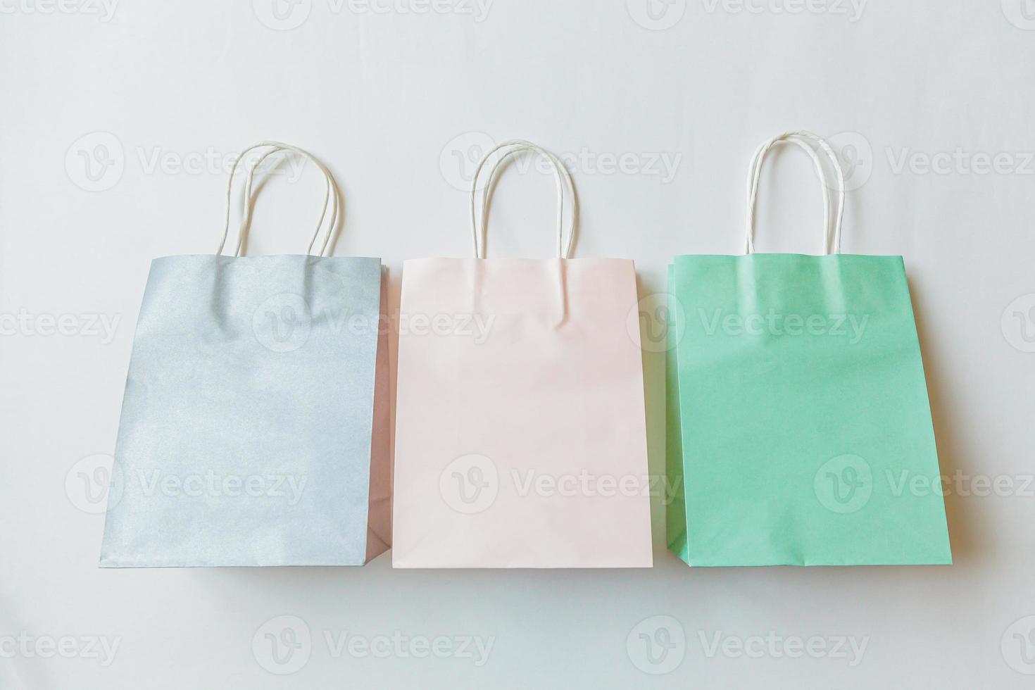 Simply minimal design three many shopping bag isolated on white background. Online or mall shopping shopaholic concept. Black friday Christmas season sale. Flat lay top view copy space, mock up photo