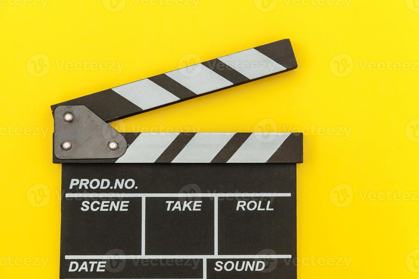 Filmmaker profession. Classic director empty film making clapperboard or movie slate isolated on yellow background. Video production film cinema industry concept. Flat lay top view copy space mock up. photo