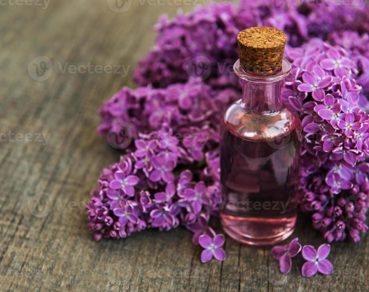 Essential oil with lilac flowers photo