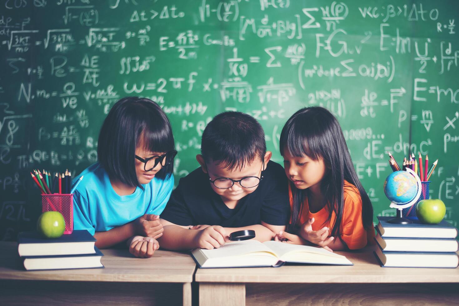 pupils  reading a book in the classroom. photo