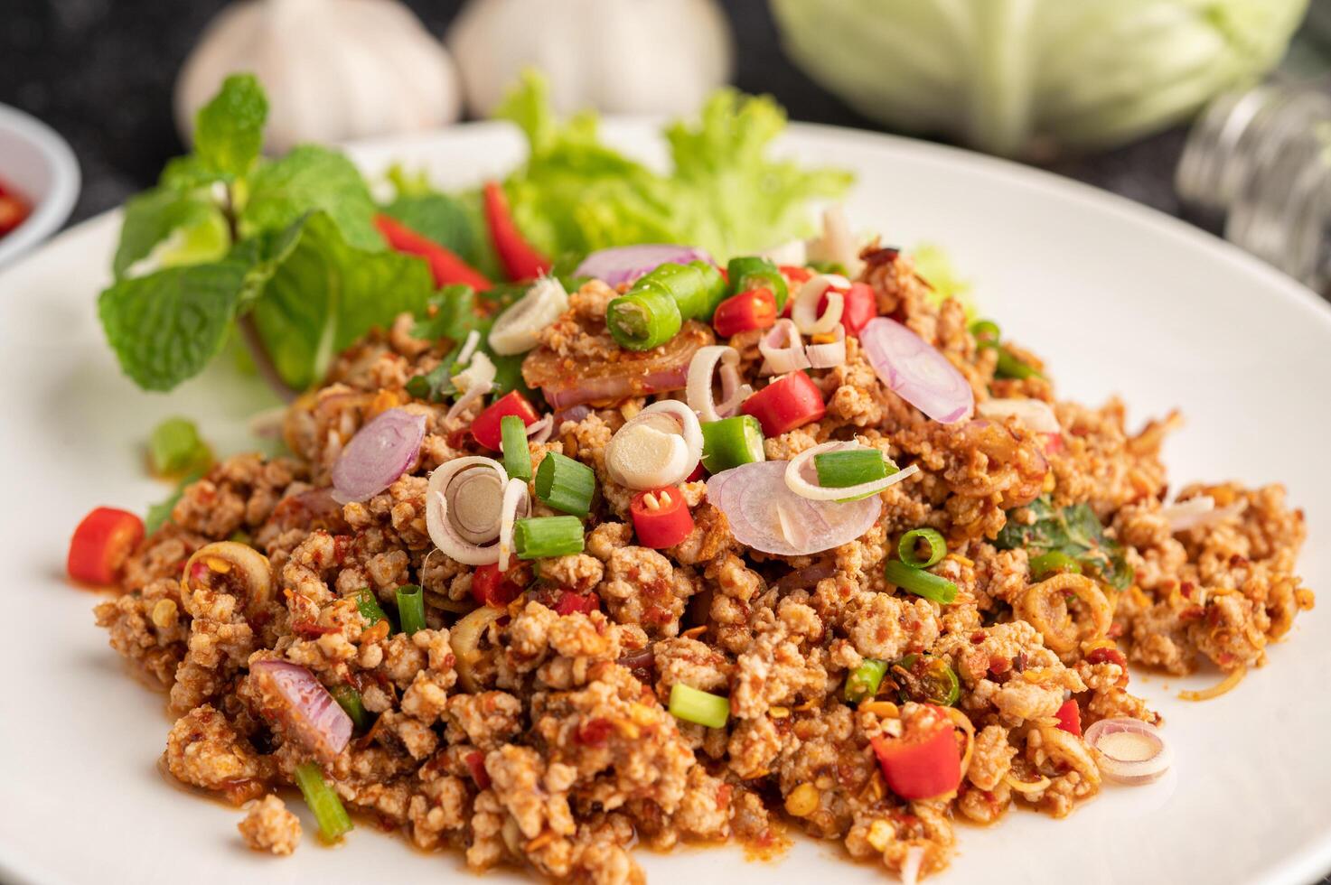 Spicy minced pork salad with chili flakes, lime, chopped green onions