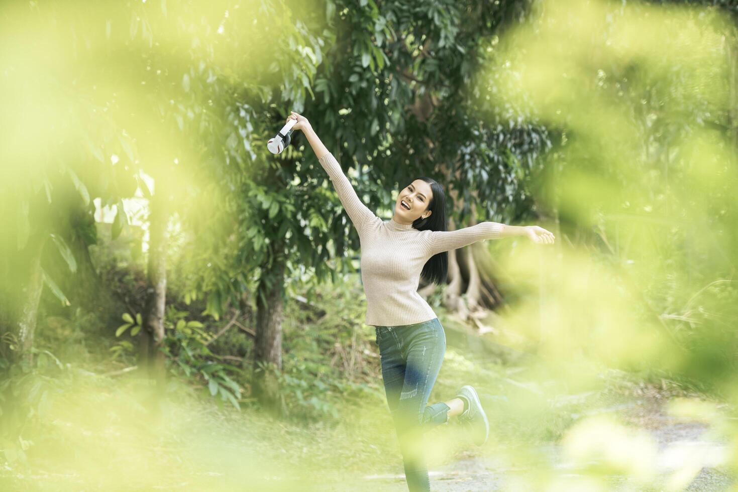 Asian woman listening favorite music on headphones. Happy time and relax. photo