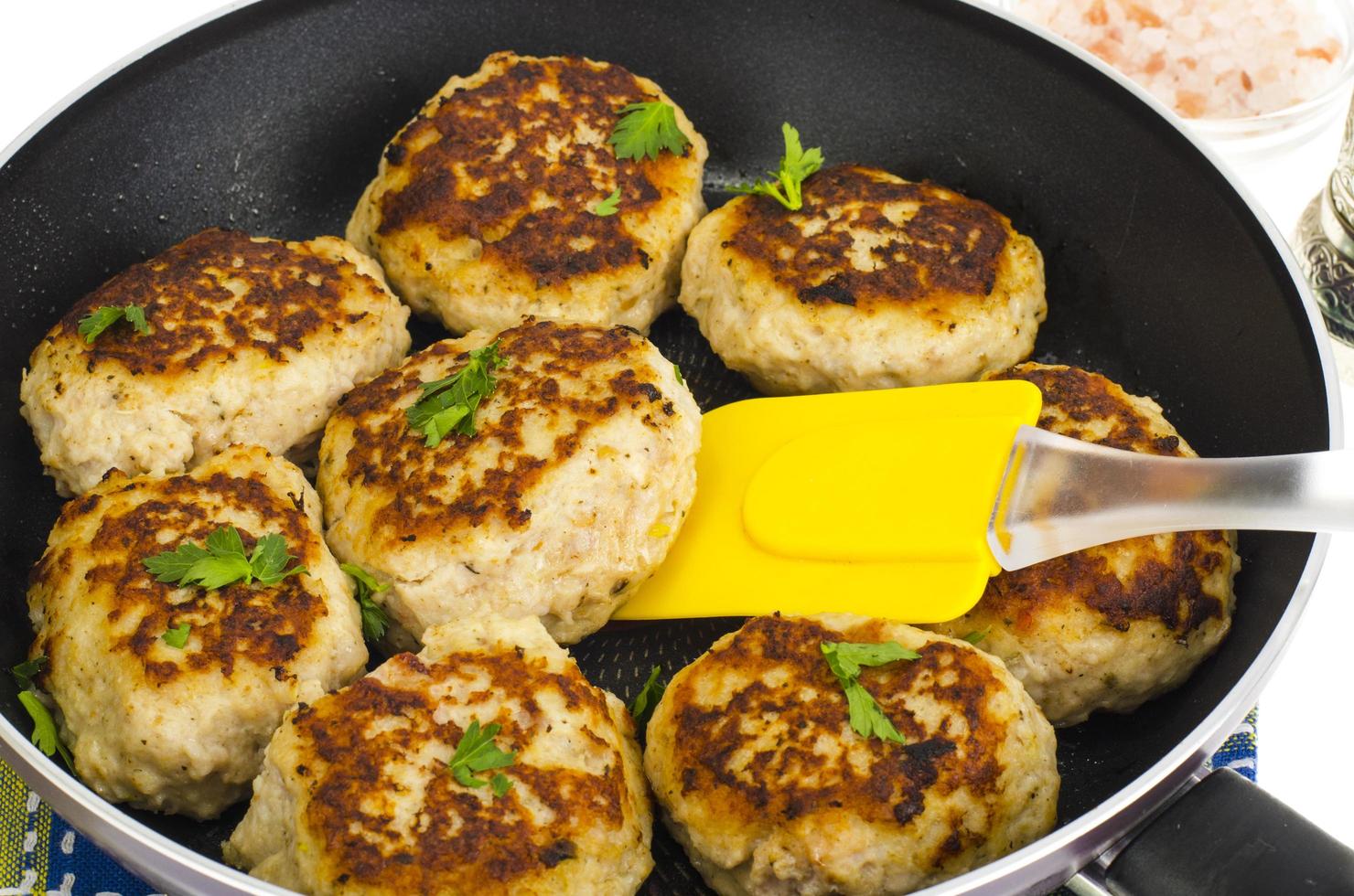 Pan with fried meat patties on white plate photo