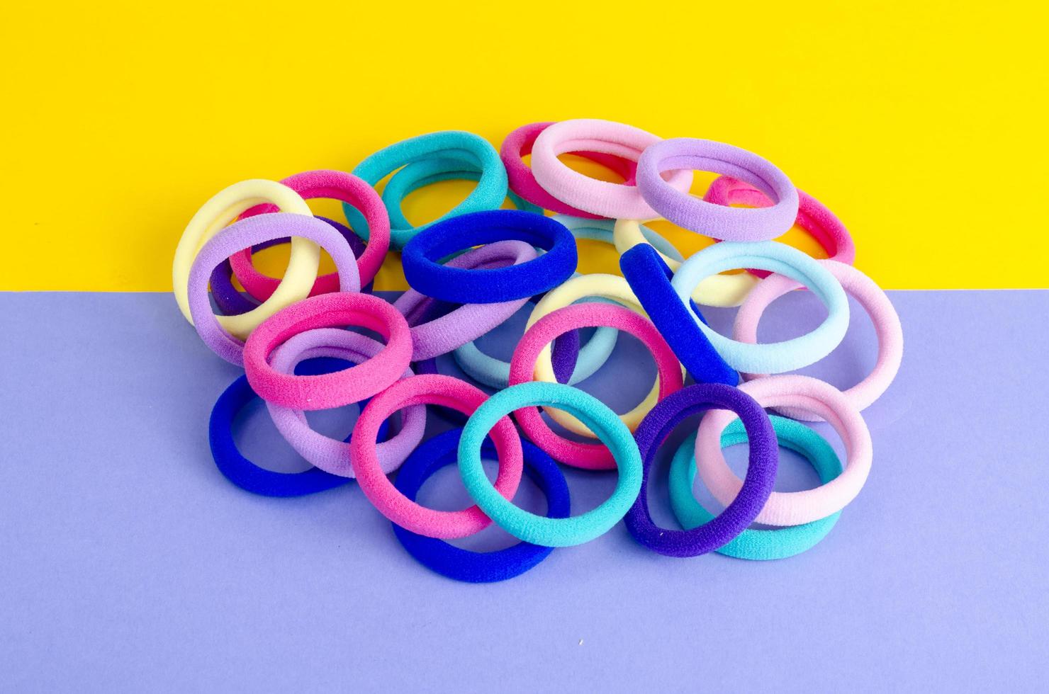 Colored hair ties on bright background. Photo
