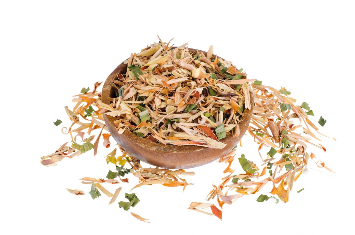 Dried lemongrass leaves in wooden bowl. photo