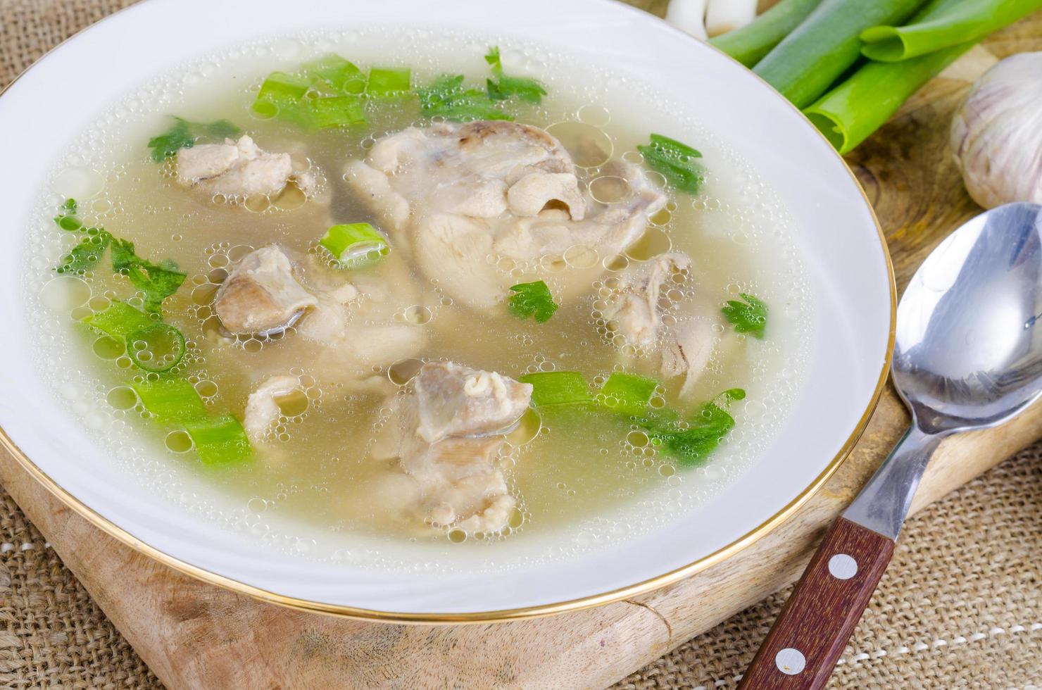 Broth with chicken meat Isolated on White background photo