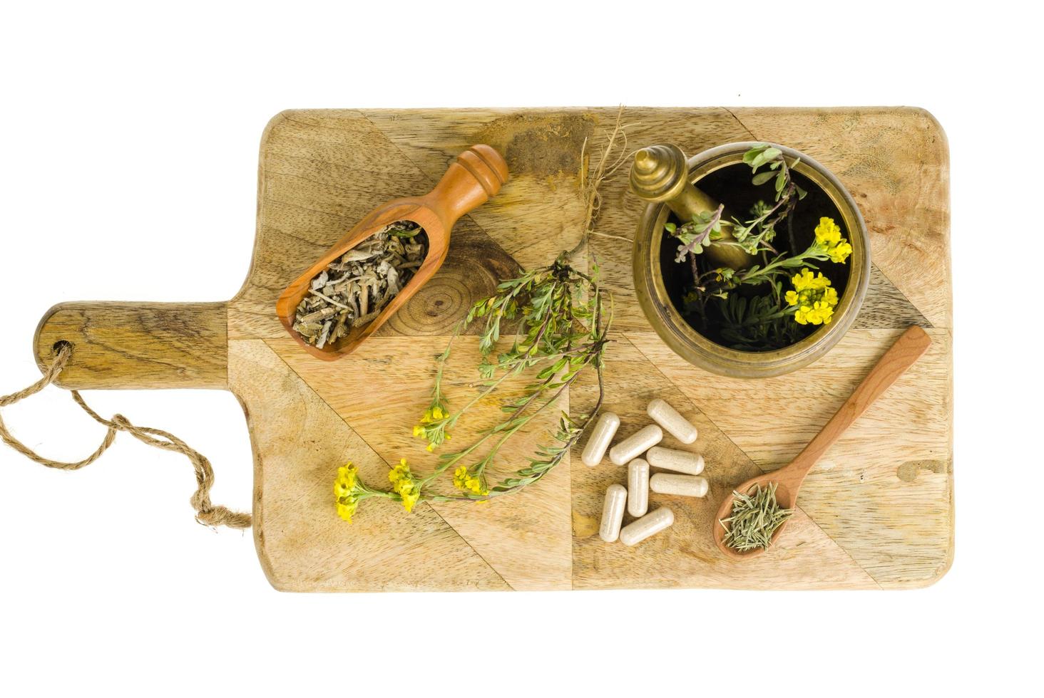Fresh and dry shredded medicinal herbs, medical capsules. photo