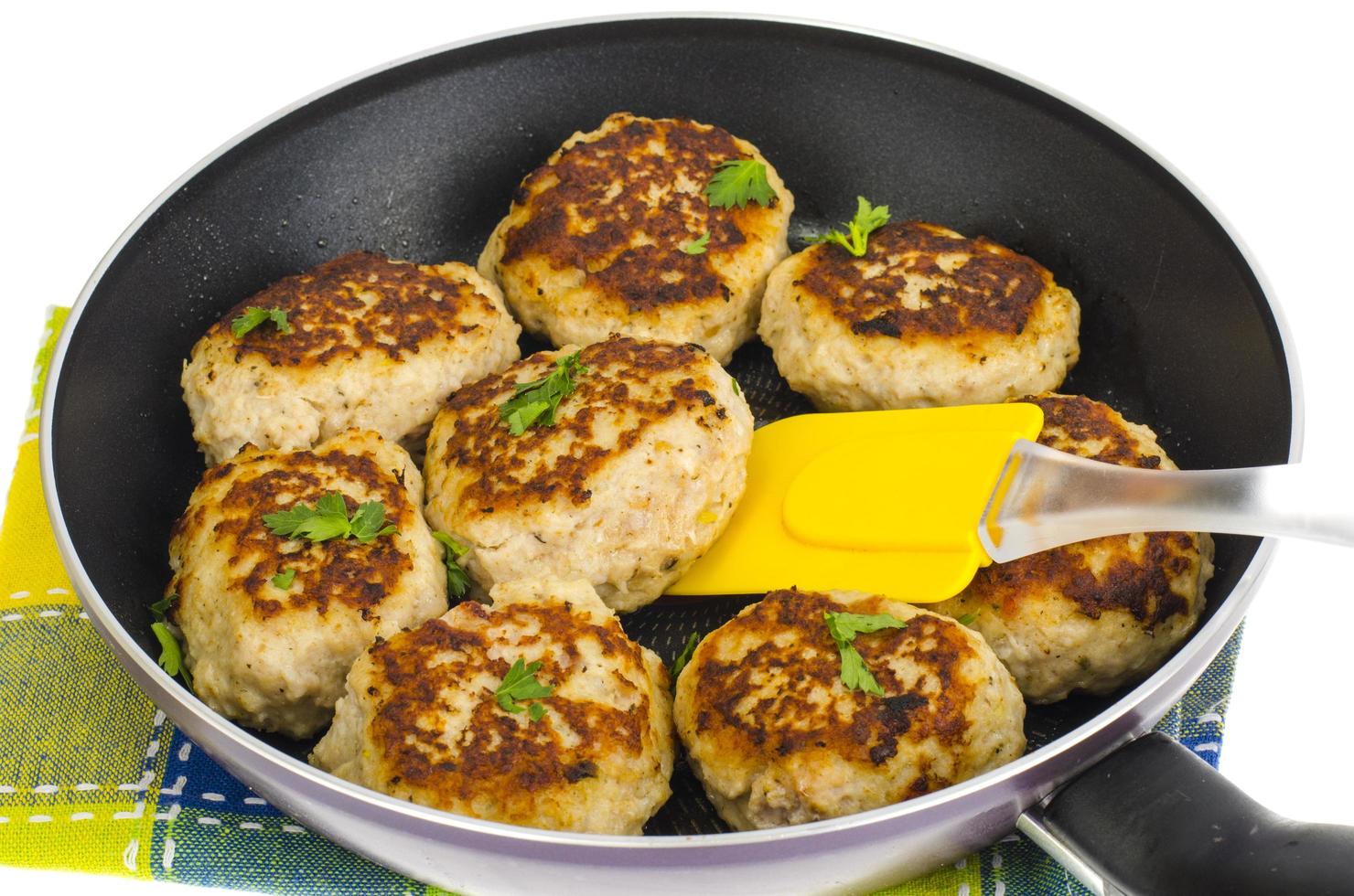 Pan with fried meat patties on white plate photo
