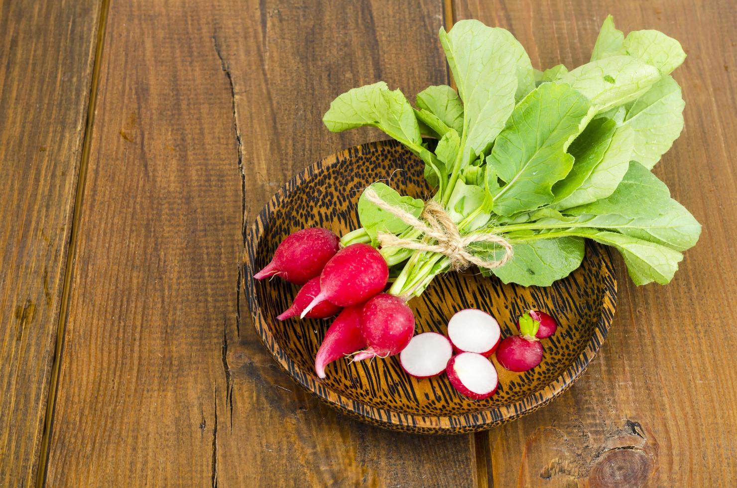 Fresh farmer bio radish on wooden plate. photo
