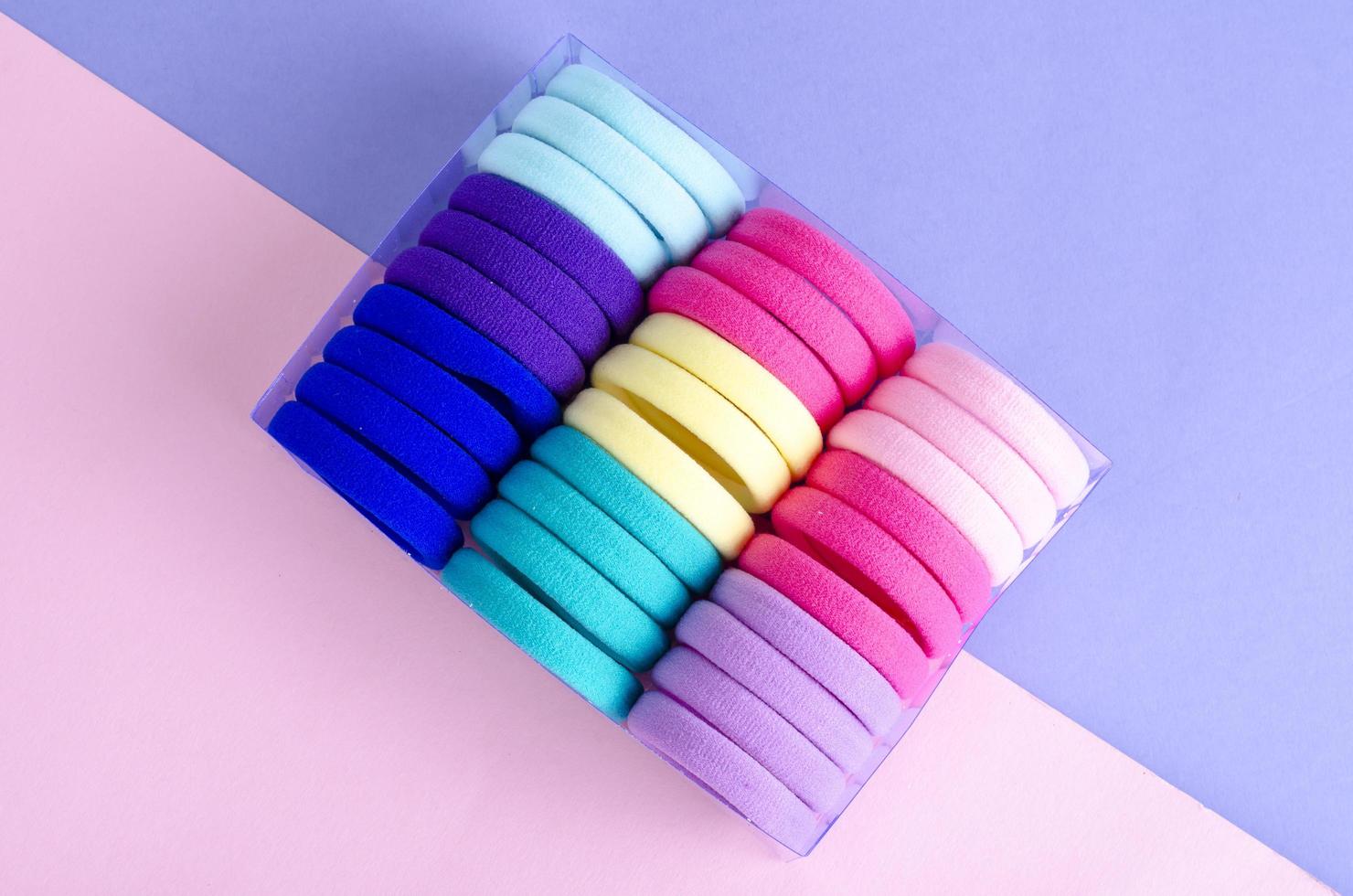Colored hair ties on bright background. Photo